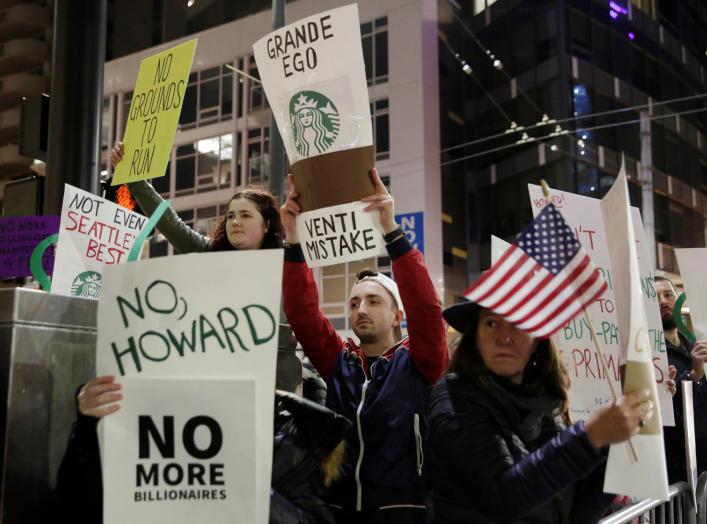 People protest outside before former Starbucks CEO Howard Schultz speaks during his book tour in Seattle, Washington, U.S., January 31, 2019. REUTERS/Jason Redmond