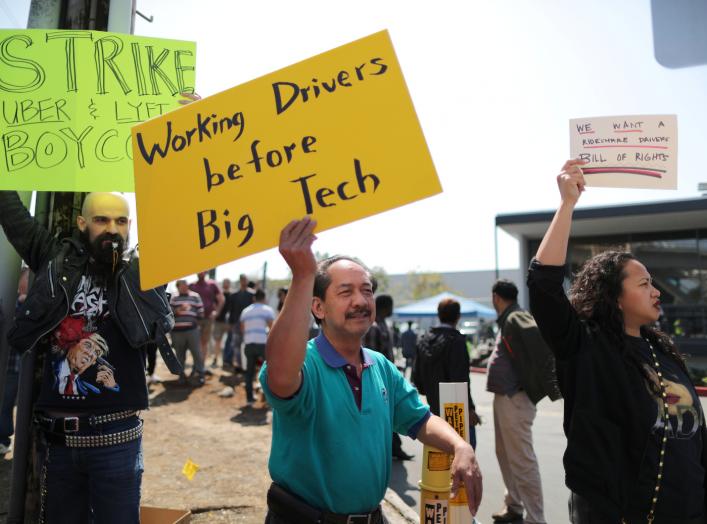 Striking Uber and Lyft drivers protest Uber's decision to cut per-mile pay from 80 cents to 60 cents, outside the Uber Hub in Redondo Beach, California, U.S., March 25, 2019. REUTERS/Lucy Nicholson