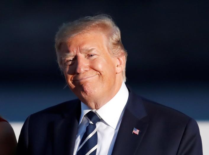 U.S. President Donald Trump and first lady Melania Trump smile during the family photo session with invited guests at the G7 summit in Biarritz, France August 25, 2019. REUTERS/Christian Hartmann/Pool