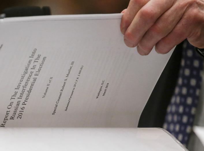 Former Special Counsel Robert Mueller references a copy of his report as he testifies before a House Judiciary Committee hearing on the Office of Special Counsel's investigation into Russian Interference in the 2016 Presidential Election on Capitol Hill