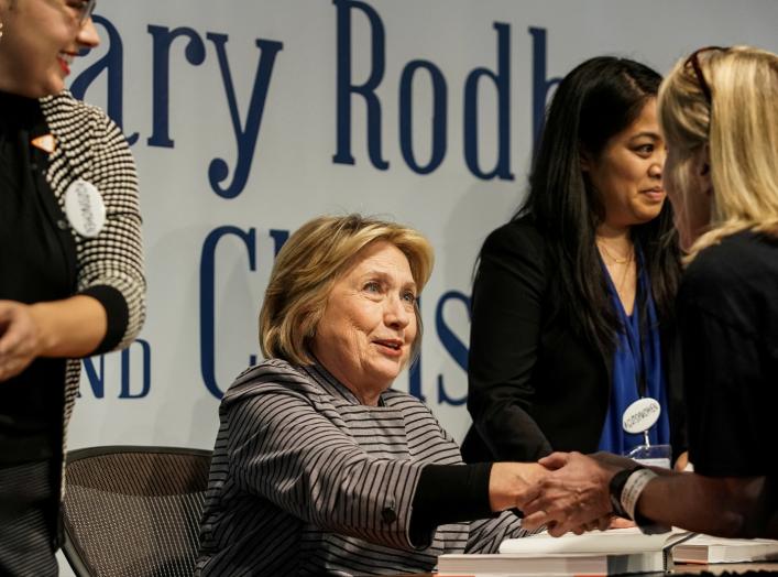 FILE PHOTO: Hillary Clinton talks to a supporter during a signing event for "The Book of Gutsy Women", a book by her and her daughter Chelsea Clinton, in the Manhattan borough of New York City, New York, U.S., October 3, 2019. REUTERS/Jeenah Moon