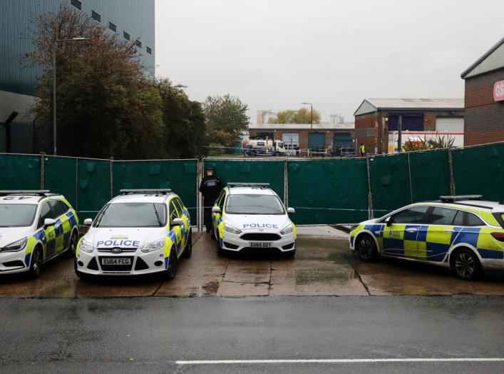 Police vehicles are seen at the scene where bodies were discovered in a lorry container, in Grays, Essex, Britain October 24, 2019. REUTERS/Simon Dawson