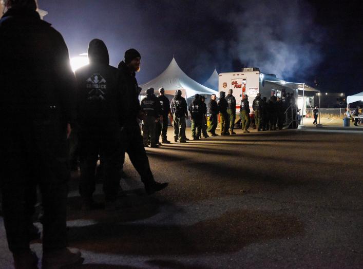 Firemen get dinner at the Cal Fire basecamp Mobile Kitchen Unit after a shift fighting the Kincaid Fire in Santa Rosa, California, U.S. October 26, 2019. Picture taken October 26, 2019. REUTERS/Kate Munsch