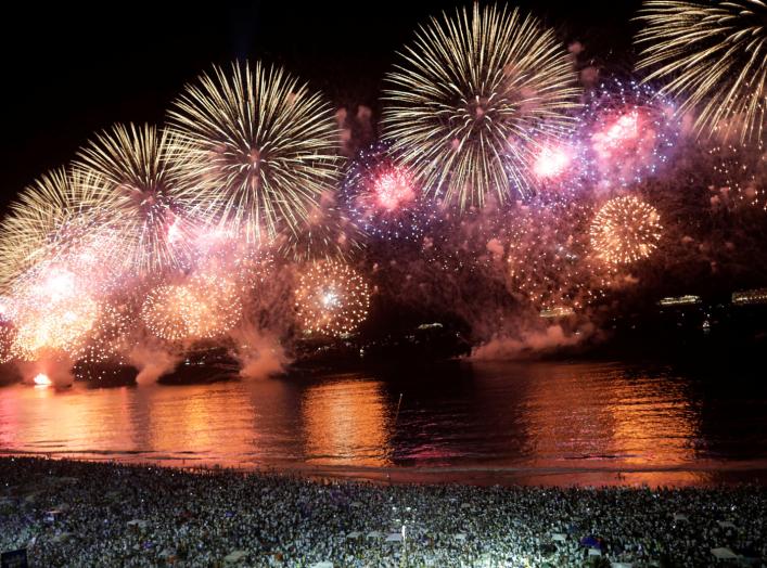 People watch as fireworks explode over Copacabana beach during New Year celebrations in Rio de Janeiro, Brazil January 1, 2020. REUTERS/Ueslei Marcelino