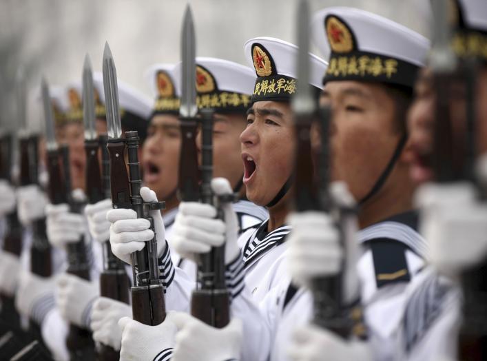 Chinese People's Liberation Army Navy recruits chant slogan during a parade to mark the end of a semester at a military base of the North Sea Fleet, in Qingdao, Shandong province December 5, 2013. REUTERS/China Daily 