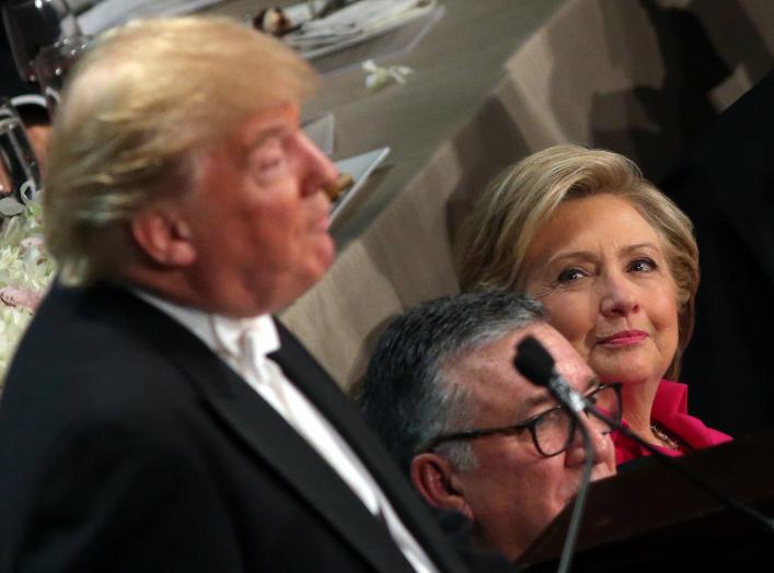 Democratic U.S. presidential nominee Hillary Clinton looks at Republican U.S. presidential nominee Donald Trump as he speaks during the Alfred E. Smith Memorial Foundation dinner in New York, U.S. October 20, 2016. REUTERS/Carlos Barria