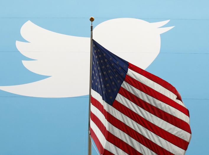 The Twitter Inc. logo is shown with the U.S. flag during the company's IPO on the floor of the New York Stock Exchange in New York, November 7, 2013. REUTERS/Lucas Jackson/File Photo