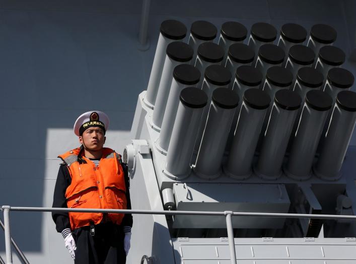 A Chinese serviceman stands beside a multibarrel rocket launcher on the deck of a naval vessel, upon its arrival to participate in Pakistan Navy’s Multinational Exercise AMAN-17, in Karachi, Pakistan, February 9, 2017. REUTERS/Akhtar Soomro