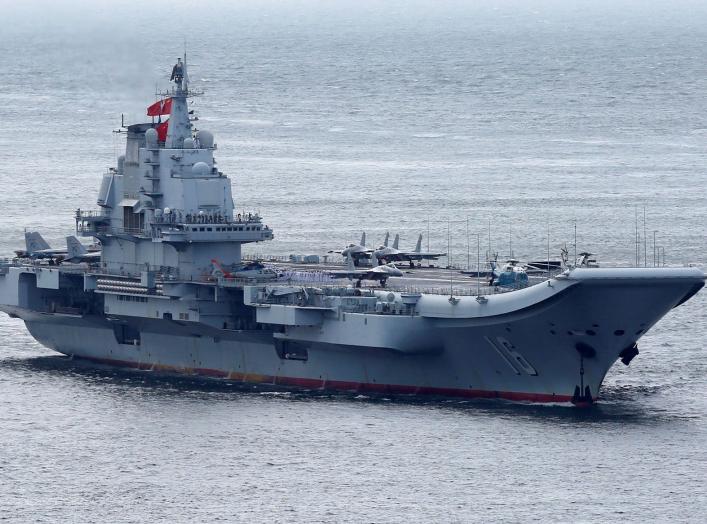 Members of the People's Liberation Army navy are seen on board China's aircraft carrier Liaoning as it sails into Hong Kong, China July 7, 2017. REUTERS/Bobby Yip