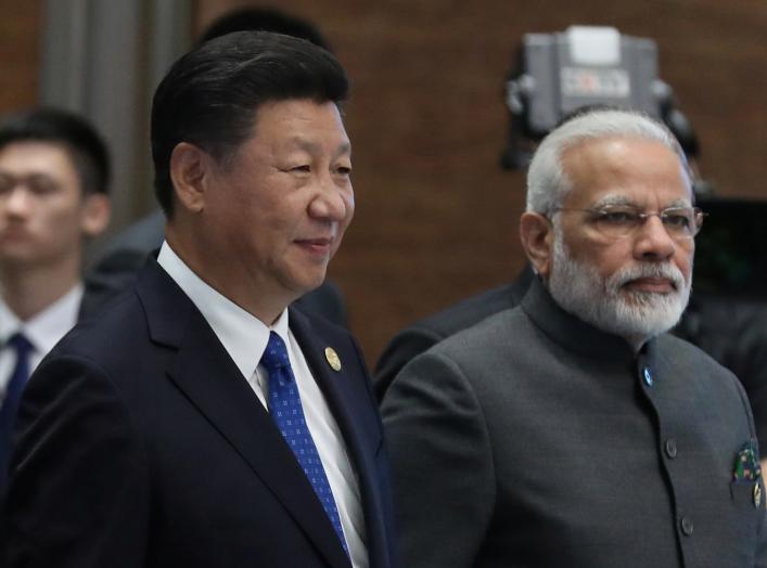 Chinese President Xi Jinping (L) and Indian Prime Minister Narendra Modi, arrive for the 'Dialogue of Emerging Market and Developing Countries' on the sidelines of the 2017 BRICS Summit in Xiamen, Fujian province, China, 05 September 2017. REUTERS/Wu Hong