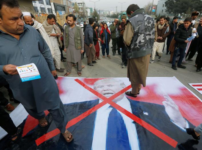 Demonstrator step onto a poster of U.S. President Donald Trump during a protest against U.S. President Donald Trump's recognition of Jerusalem as Israel's capital, in Kabul, Afghanistan, December 8, 2017 REUTERS/Omar Sobhani