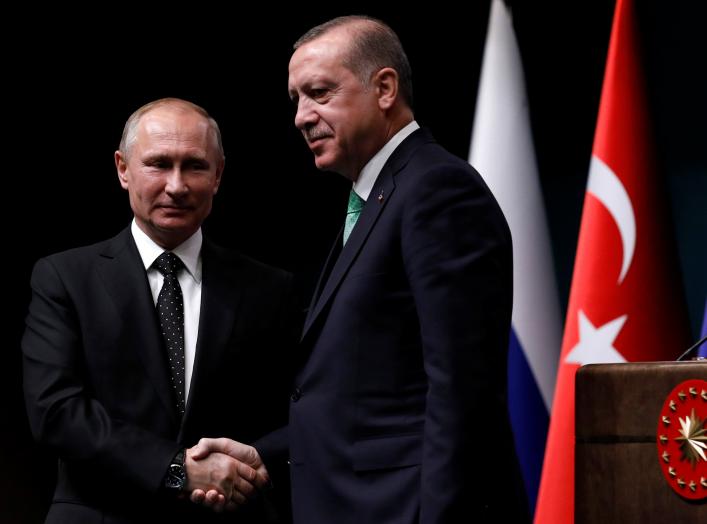 Turkish President Tayyip Erdogan shakes hands with Russian President Vladimir Putin after a news conference in Ankara, Turkey, December 11, 2017. REUTERS/Umit Bektas