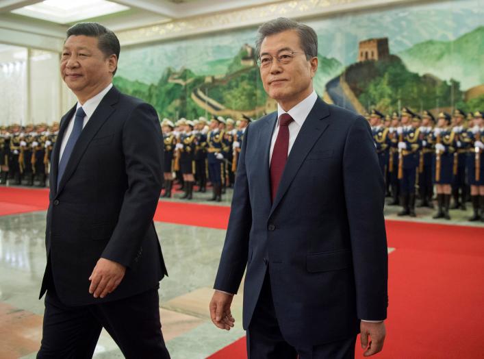 South Korean President Moon Jae-In and Chinese President Xi Jinping review the Chinese honour guard during a welcome ceremony at the Great Hall of the People in Beijing, China December 14, 2017. REUTERS/Nicolas Asfouri/Pool