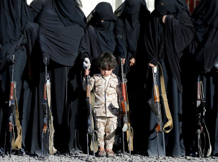 A boy stands with women loyal to the Houthi movement during a gathering held to show their support to the movement in Sanaa, Yemen January 14, 2018. REUTERS/Khaled Abdullah TPX IMAGES OF THE DAY