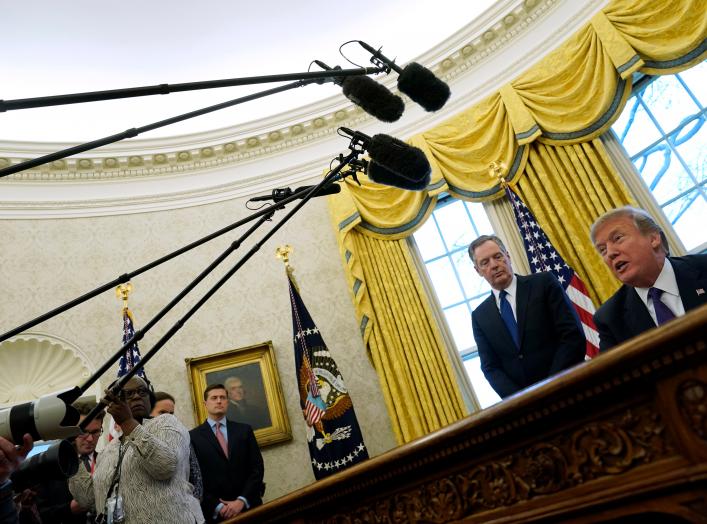 U.S. Trade Representative Robert Lighthizer stands behind U.S. President Donald Trump as Trump prepares to sign directives to impose tariffs on imported washing machines and solar panels in the Oval Office at the White House in Washington, U.S. January 23