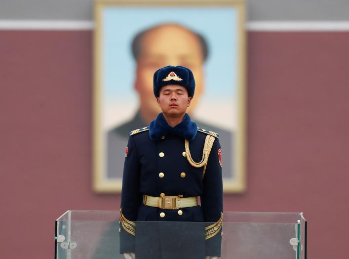 A member of Chinese People's Liberation Army (PLA) stands guard in front of a portrait of late Chinese Chairman Mao Zedong at the Tiananmen in Beijing, China March 4, 2018.