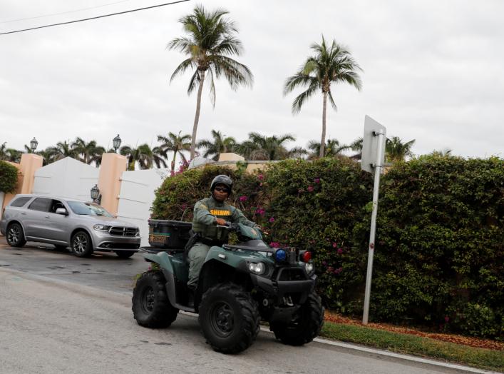 A police officer secures the entrance to U.S. President Donald Trump's Mar-a-Lago estate in Palm Beach, Florida, U.S., March 31, 2018. REUTERS/Yuri Gripas