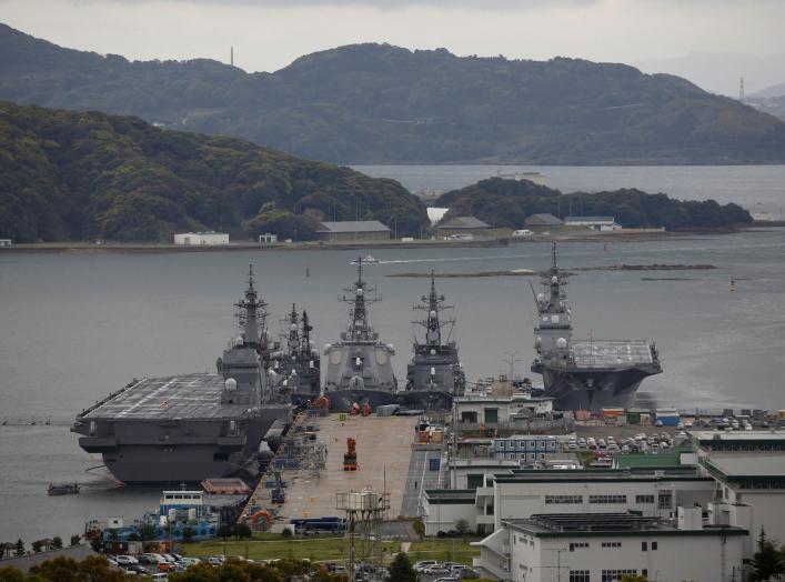 Japan Maritime Self-Defense Force's (JMSDF) latest Izumo-class helicopter carrier DDH-184 Kaga (L) and other JMSDF destroyers DD-157 Sawagari, DDG-176 Chokai, DD-104 Kirisame and DDH-182 Ise are moored at a naval base in Sasebo, on the southwest island of