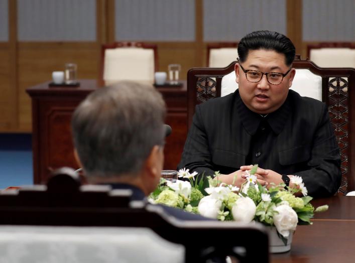 North Korean leader Kim Jong Un talks to South Korean President Moon Jae-in during their meeting at the Peace House at the truce village of Panmunjom inside the demilitarized zone separating the two Koreas, South Korea, April 27, 2018.