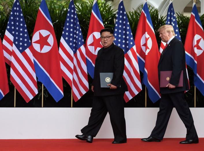 U.S. President Donald Trump and North Korea's leader Kim Jong Un walk during their summit at the Capella Hotel on Sentosa island in Singapore June 12, 2018. Anthony Wallace/Pool via Reuters TPX IMAGES OF THE DAY