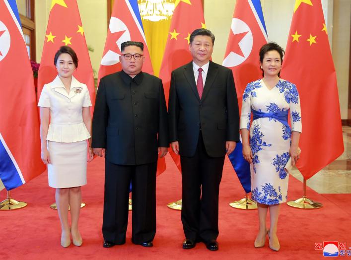 North Korean leader Kim Jong Un and his wife Ri Sol Ju pose beside Chinese President Xi Jinping and his wife Peng Liyuan in Beijing, China, in this undated photo released June 20, 2018 by North Korea's Korean Central News Agency.