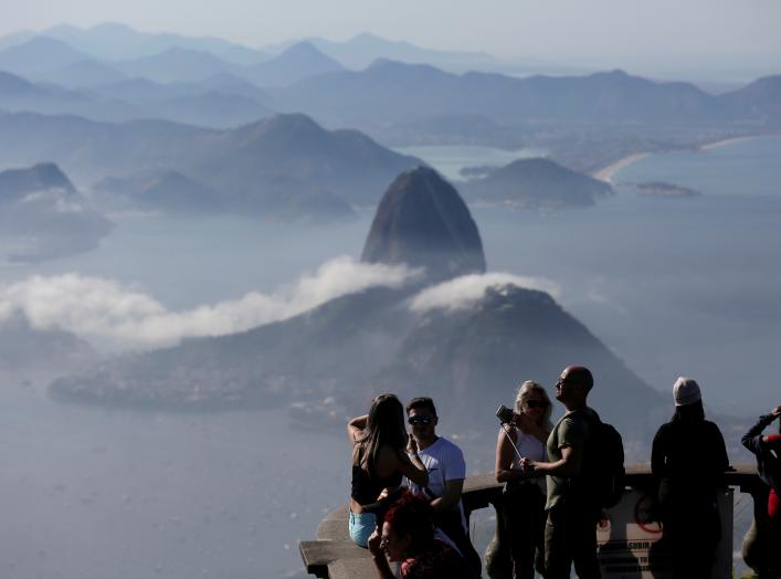 Tourists are seen with the Sugarloaf Mountain in the background in Rio de Janeiro, Brazil June 21, 2018. REUTERS/Bruno Kelly