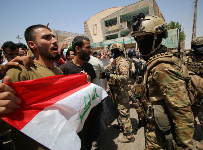 Iraqi security forces stand guard as demonstrators protest in front of Basra provincial council building, demanding jobs and better state services, in Basra, Iraq July 31, 2018. REUTERS/Essam al-Sudani