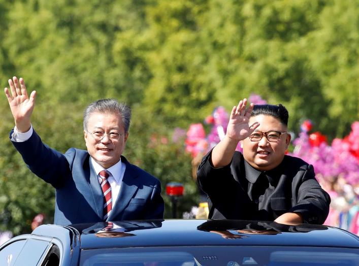 FILE PHOTO: South Korean President Moon Jae-in and North Korean leader Kim Jong Un wave during a car parade in Pyongyang, North Korea, September 18, 2018. Pyeongyang Press Corps/Pool via REUTERS/File Photo