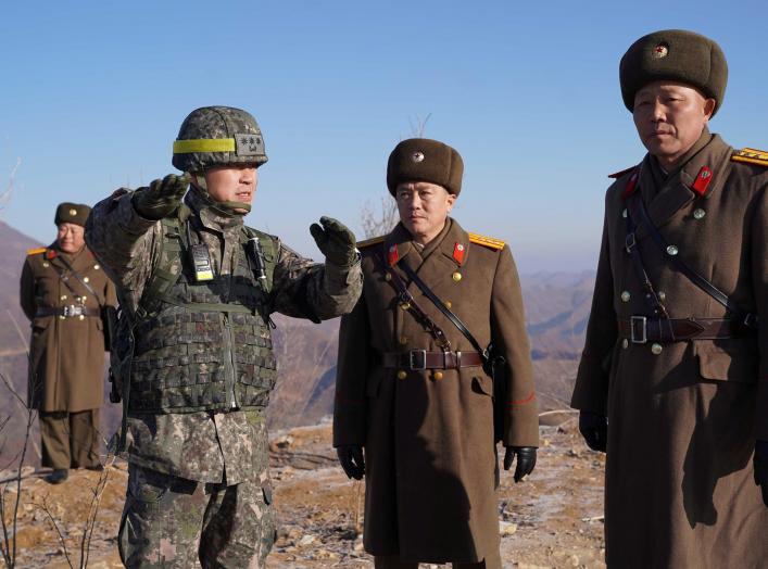 Soldiers from North and South Korea verify the removal of guard posts on each side of the Demilitarized Zone, December 12, 2018. South Korean Defence Ministry/Handout via REUTERS THIS IMAGE HAS BEEN SUPPLIED BY A THIRD PARTY.