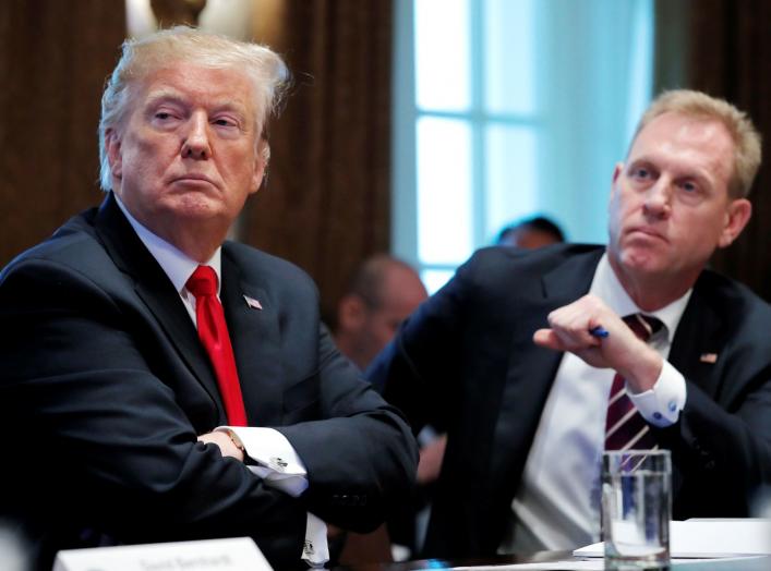 U.S. President Donald Trump listens next to Acting U.S. Defense Secretary Patrick Shanahan during a Cabinet meeting on day 12 of the partial U.S. government shutdown at the White House in Washington, U.S., January 2, 2019. REUTERS/Jim Young