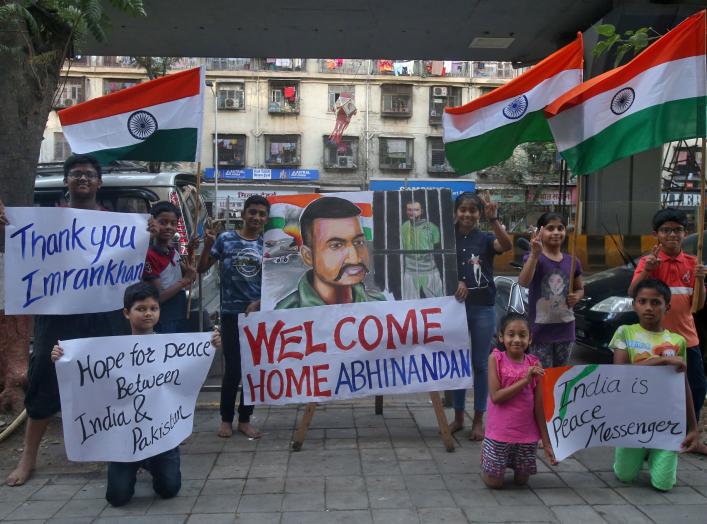 Children hold banners and Indian national flags after Pakistan's Prime Minister Imran Khan said Pakistan will release an Indian Air Force pilot on Friday, in a street in Mumbai, India, February 28, 2019. REUTERS/Francis Mascarenhas