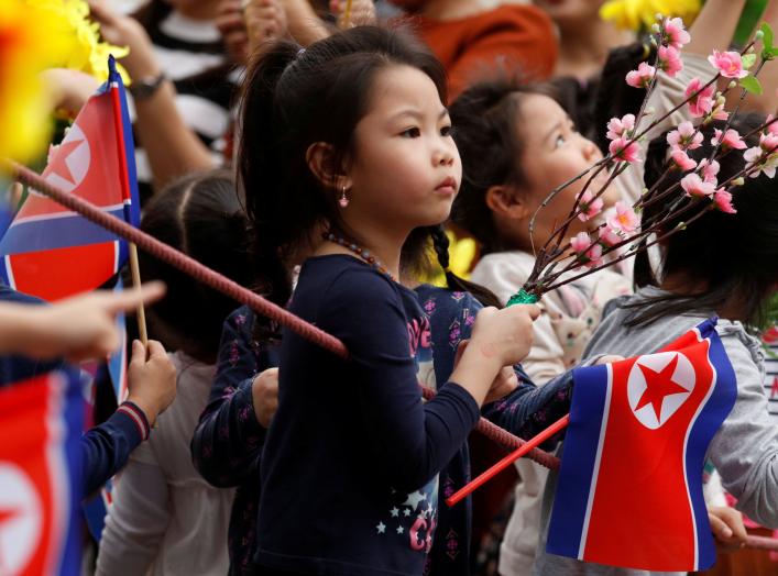 Children wait for the motorcade carrying North Korea's leader Kim Jong Un to pass, in Hanoi, Vietnam, March 1, 2019. REUTERS/Jorge Silva