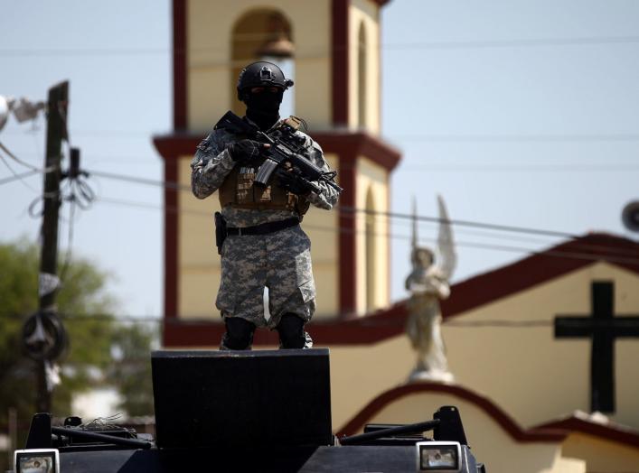 A soldier stands guard after a blockade set by members of the Santa Rosa de Lima Cartel to repel security forces during an anti-fuel theft operation in Santa Rosa de Lima, in Guanajuato state, Mexico, March 6, 2019. REUTERS/Edgard Garrido