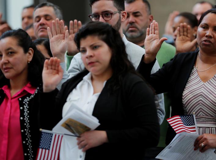 Immigrants take the Oath of Allegiance to become a U.S. citizens during an official Naturalization Ceremony at the Museum of Fine Arts, Boston in Boston, Massachusetts, U.S., May 6, 2019. REUTERS/Brian Snyder