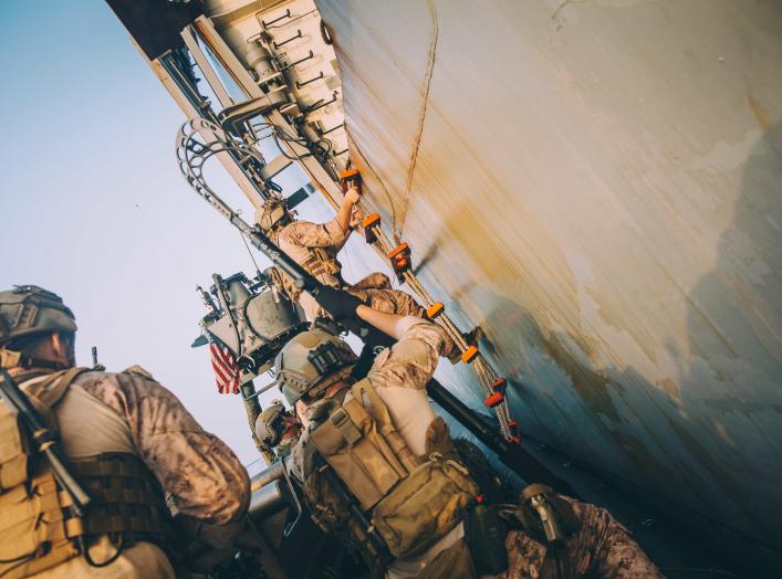 Marines with the Maritime Raid Force, 11th Marine Expeditionary Unit (MEU) climb a ladder to board the amphibious transport dock ship USS John P. Murtha (LPD 26) during a visit, board, search and seizure training exercise in the Gulf, in this undated