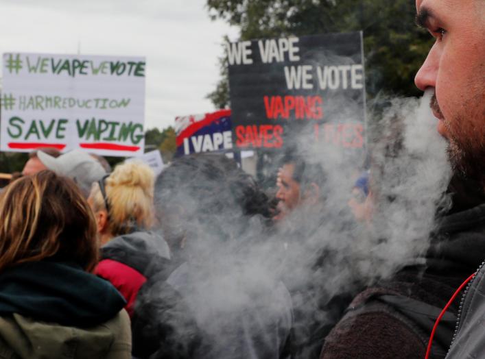 A demonstrator vapes during a protest at the Massachusetts State House against the state’s four-month ban of all vaping product sales in Boston, Massachusetts, U.S., October 3, 2019. REUTERS/Brian Snyder