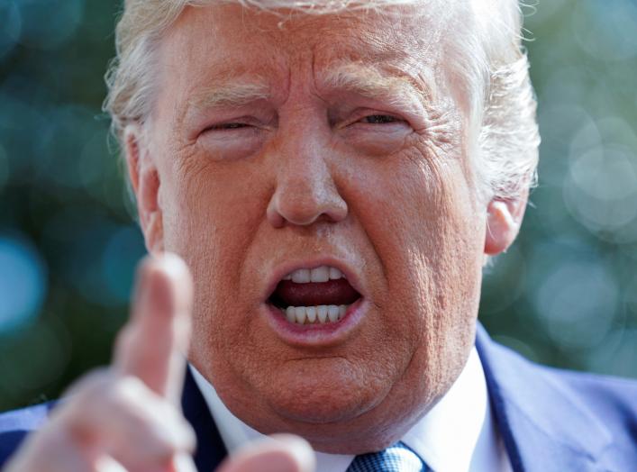 U.S. President Donald Trump talks to reporters as he heads to the Marine One helicopter to fly from the South Lawn to visit injured members of the U.S. military at Walter Reed National Military Medical Center from the White House.