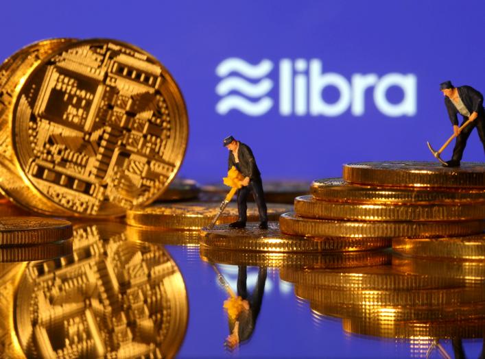 Small toy figures are seen on representations of virtual currency in front of the Libra logo in this illustration picture, June 21, 2019. REUTERS/Dado Ruvic