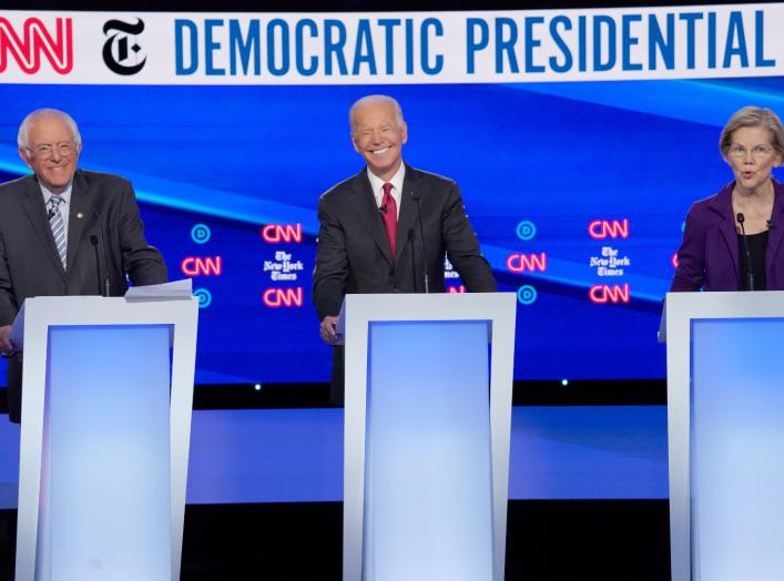  Democratic presidential candidates Senator Bernie Sanders and former Vice President Joe Biden listen to Senator Elizabeth Warren as they debate during the fourth U.S. Democratic presidential candidates 2020 election debate in Westerville, Ohio