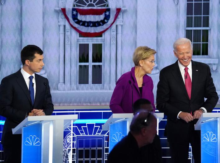 South Bend Mayor Pete Buttigieg looks on as Senator Elizabeth Warren and former Vice President Joe Biden talk during a break in the U.S. Democratic presidential candidates debate at the Tyler Perry Studios in Atlanta, Georgia, U.S. November 20, 2019.