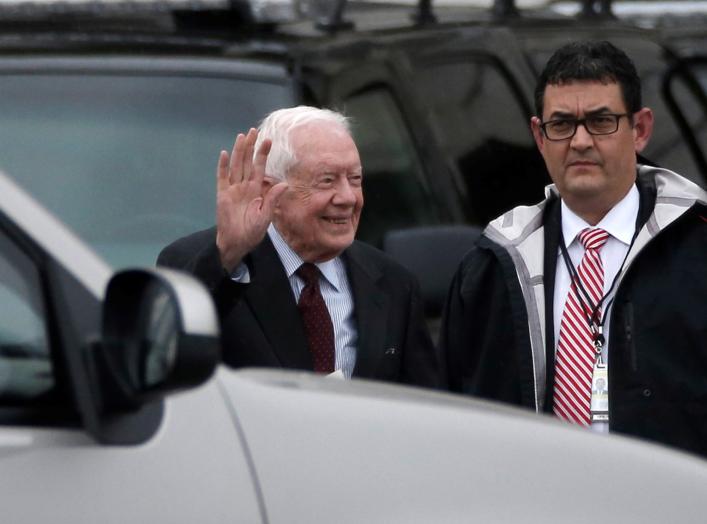 FILE PHOTO: Former U.S. President Jimmy Carter waves as he departs the Capitol after attending the presidential inauguration of Donald Trump in Washington, U.S., January 20, 2017. REUTERS/Mike Segar/File Photo