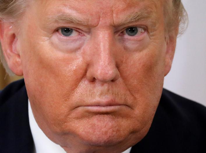 U.S. President Donald Trump reacts during the meeting with France's President Emmanuel Macron, ahead of the NATO summit in Watford, in London, Britain, December 3, 2019. Ludovic Marin/Pool via REUTERS