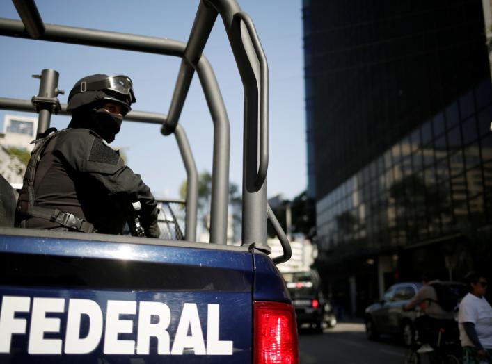 A federal police officer keeps watch after the U.S. Attorney General William Barr's convoy arrived at the Mexico's Attorney General Office (FGR) ahead of his meeting with the Mexican Attorney General Alejandro Gertz Manero, in Mexico City, Mexico