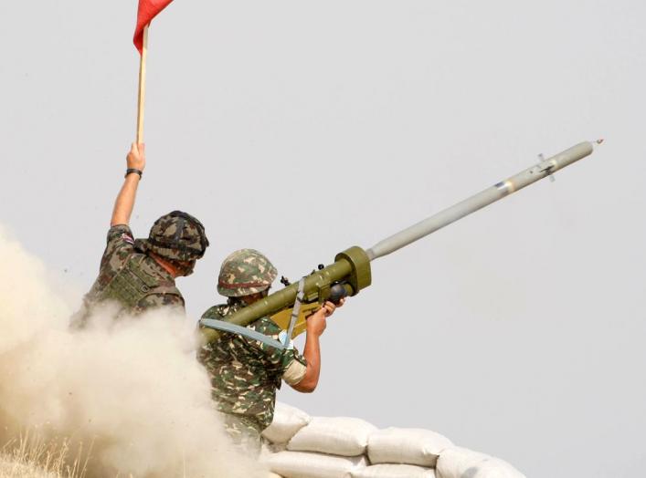 Macedonian soldiers fire an anti-aircraft missile with the Russian-made Igla ground-to-air launcher, supervised by a Slovenian military instructor, during a live fire exercise on September 12, 2008 at the Krivolak training ground, some 120 km (75 miles) s