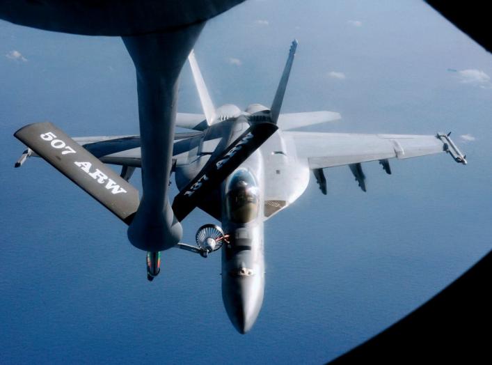 An FA-18 air fighter from the U.S. carrier George Washington is being refuelled by an air tanker over the Pacific near Okinawa Island, southern Japan, December 9, 2010. REUTERS/Kyodo (JAPAN - Tags: MILITARY TRANSPORT) JAPAN OUT. NO COMMERCIAL OR EDITORIAL