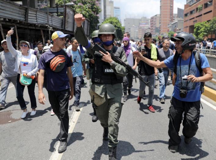 A Venezuelan National Guard member gestures, after joining anti-government protesters in a march, showing his support for opposition leader Juan Guaido in Caracas, Venezuela April 30, 2019. REUTERS/Manaure Quintero.