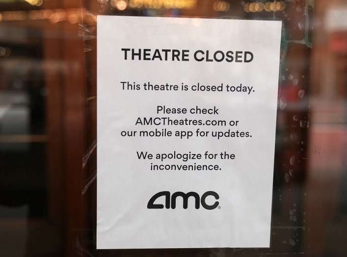 A sign is displayed on the window of a movie theater in Times Square following the outbreak of coronavirus disease (COVID-19), in the Manhattan borough of New York City, New York, U.S. March 17, 2020. REUTERS/Carlo Allegri