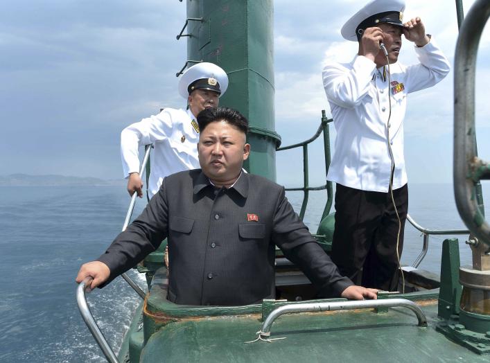 North Korean leader Kim Jong Un stands on the conning tower of a submarine during his inspection of the Korean People's Army Naval Unit 167 in this undated photo released June 16, 2014. 