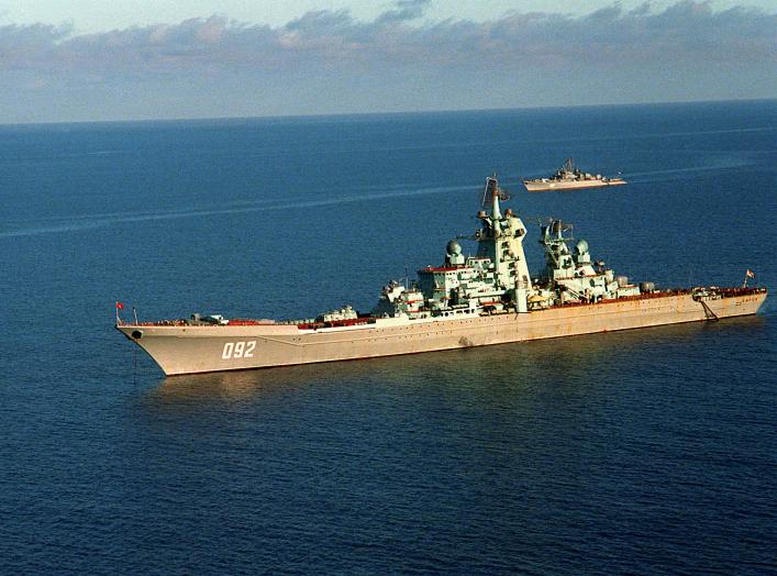 A port view of the Soviet nuclear-powered guided missile cruiser KIROV at anchor. In the background is a Soviet Krivak I-class guided missile frigate.