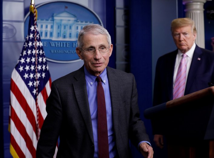 National Institute of Allergy and Infectious Diseases director Dr. Anthony Fauci turns the podium over to U.S. President Donald Trump during the coronavirus response daily briefing at the White House in Washington, U.S., April 10, 2020. REUTERS/Yuri Gripa